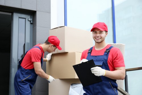 Professional movers handling office equipment